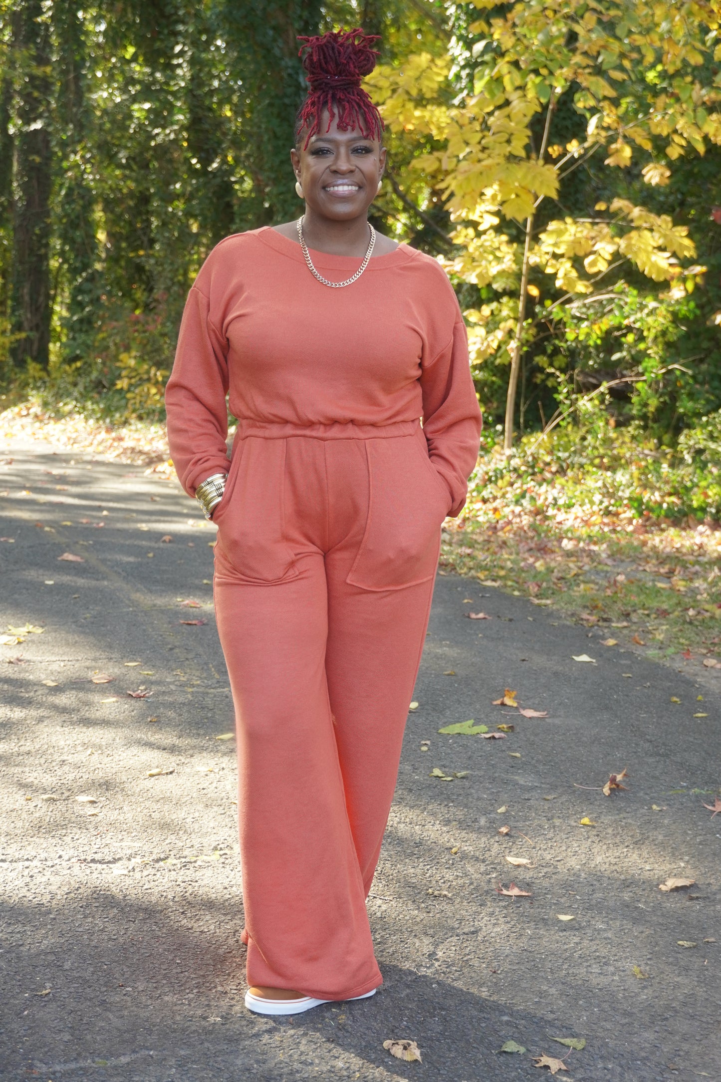 RUST LONG SLEEVE WIDE PANTS JUMPSUIT W/POCKETS AND OPEN BACK
