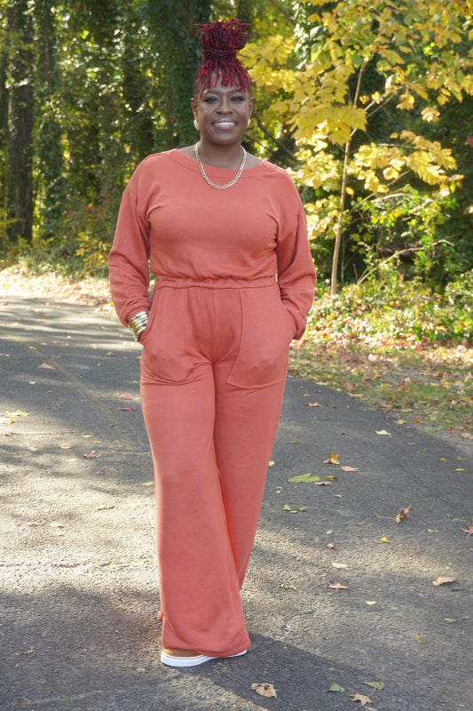 RUST LONG SLEEVE WIDE PANTS JUMPSUIT W/POCKETS AND OPEN BACK